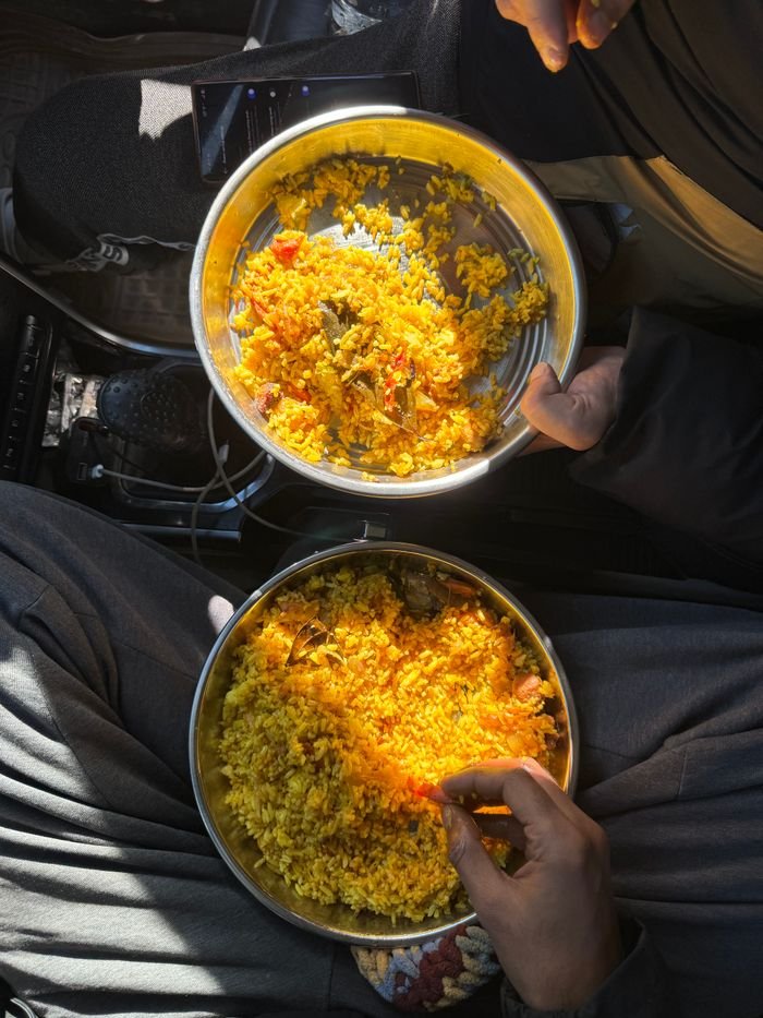 The Art of Drawing Readers In: Your attractive post title goes here Overhead shot of two people sharing biryani in a car